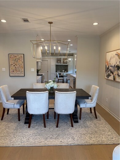 Dining room featuring a chandelier, crown molding,