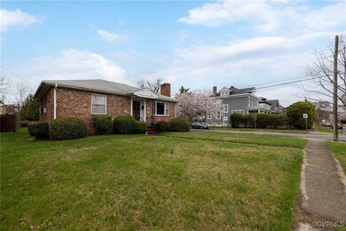 View of front of home with a front lawn, a chimney
