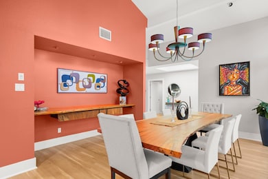 Dining area with a high ceiling, wood finished fl
