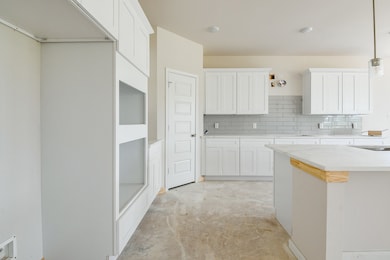 Notice the crisp white cabinetry that offers ample