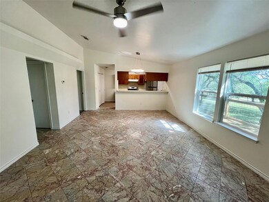Unfurnished living room featuring a ceiling fan, 