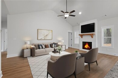 Living room with a fireplace, ceiling fan, light wood-style floors, high vaulted ceiling, and baseboards