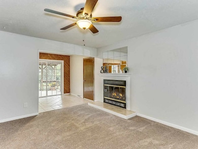Living room is complete with woodburning fireplace