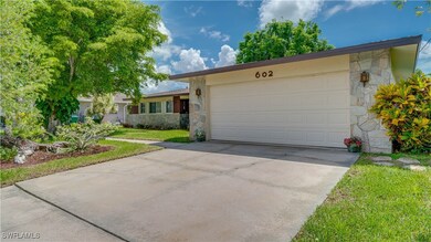 Ranch-style home with a garage and a front lawn