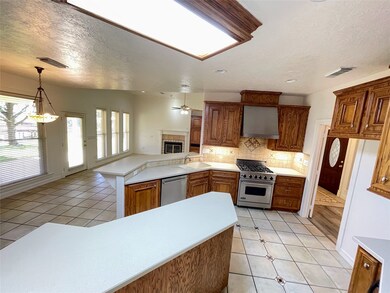 Kitchen features custom cabinetry, Viking Range and oven, extra seating at the bar.