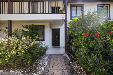 View of exterior entry with stucco siding and a ba