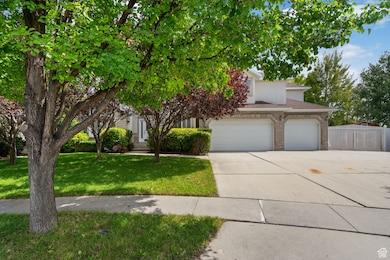 Obstructed view of property featuring driveway and brick siding