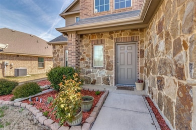 View of exterior entry with central AC unit