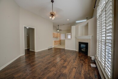 Unfurnished living room with ceiling fan, a firepl