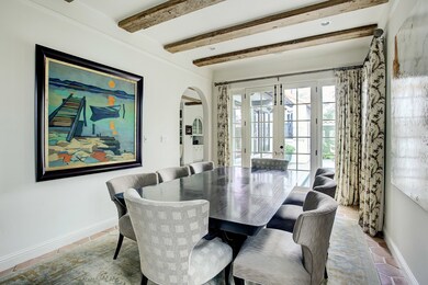 French doors lead out to the captivating patio and create an incredible ambiance.  Filled with light from three sides, there are beautiful views of the gardens from each window.