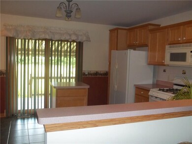 Kitchen looking out toward sliding glass doors to 