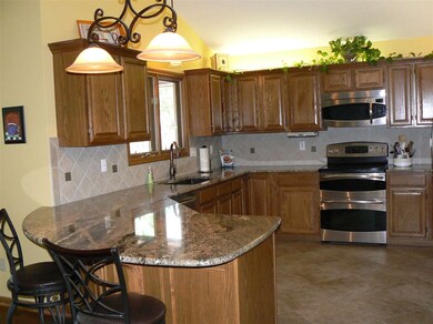A cook's dream kitchen with granite, stainless ste
