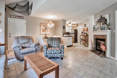 Living room with ceiling fan with notable chandeli