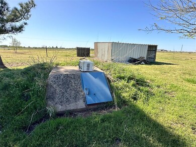View of storm shelter with a rural view and a stor