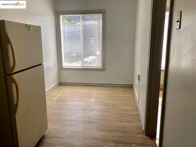 Unfurnished dining area with wood finished floors and baseboards