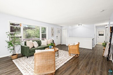 Living room featuring cooling unit and hardwood / 