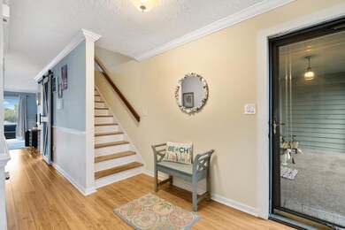 Interior space featuring baseboards, stairway, orn