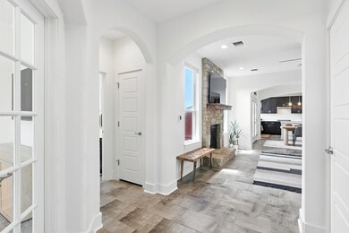 Corridor with recessed lighting and arched walkwa