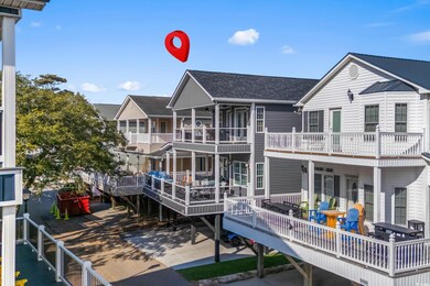 Rear view of property with a shingled roof
