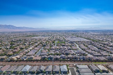 Aerial view of property's location featuring nearby suburban area and mountains