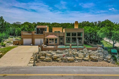 View of front of home with driveway, a chimney, s