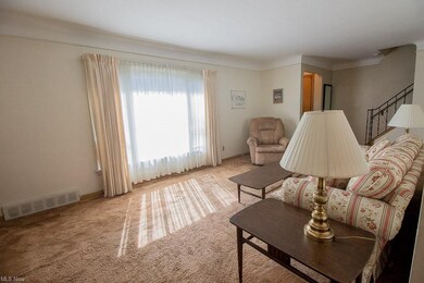 Second view of living room that features the foyer