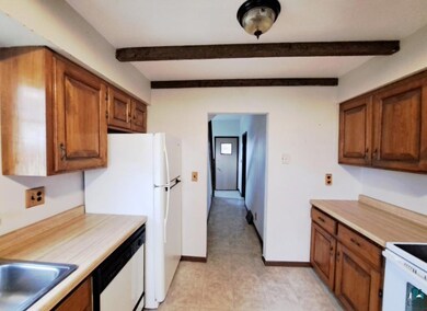 Kitchen with dishwasher, stove, beam ceiling, and 