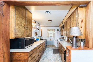 Galley style kitchen featuring Corian countertops 