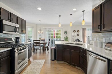 Kitchen featuring a hanging light fixtures, backsp