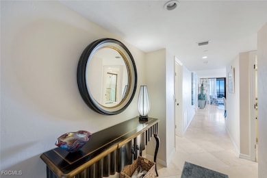 Hallway with light tile patterned floors and recessed lighting