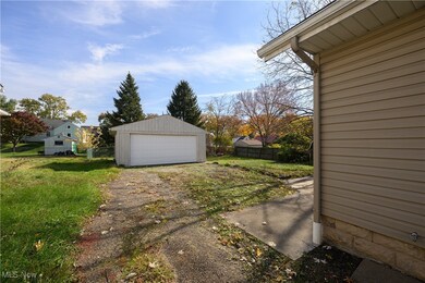 View of yard with long driveway