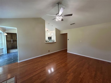 Unfurnished living room with a ceiling fan, vault