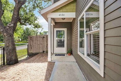 An adorable side entrance is blanketed in shade an