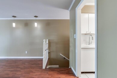 Hall with hardwood / wood-style floors, sink, and 