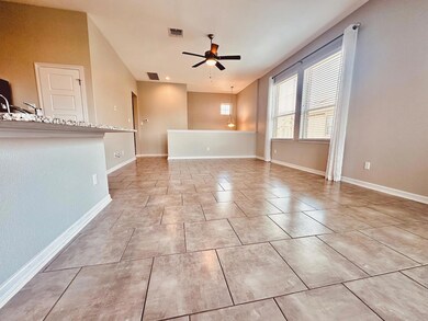 Spare room with ceiling fan, baseboards, and ligh