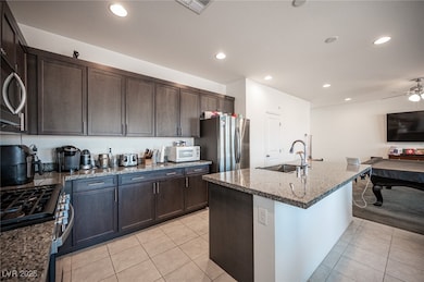 Kitchen featuring a sink, stainless steel applianc