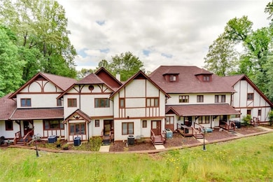 Rear view of house featuring stucco siding, a chimney, and a patio