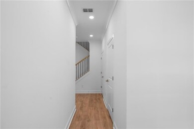 light flooring, white walls, foyer/entry way with powder room and hall closet for all rain gear, jackets, etc.