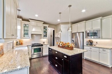 Timeless white cabinetry, granite tops and stainle