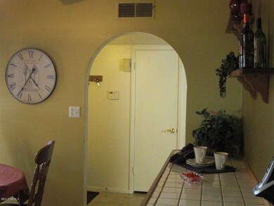 Kitchen facing hall entry closet