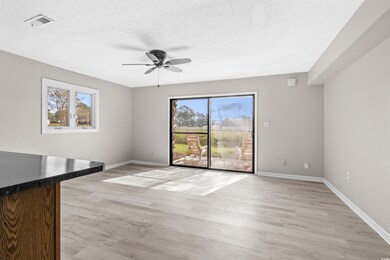 Unfurnished living room with ceiling fan, a textur