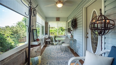 Enclosed 3 season porch on left side of home