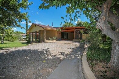 Driveway leads to covered patio