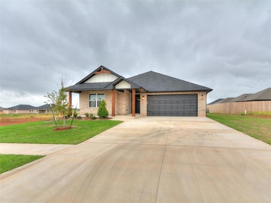 View of front facade with brick siding, roof with shingles, concrete driveway, and a garage