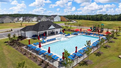 View of swimming pool with a playground, a patio a