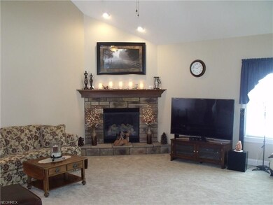 Great room with fireplace and cathedral ceilings.