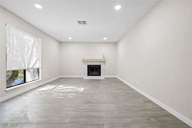 Unfurnished living room with recessed lighting, wo