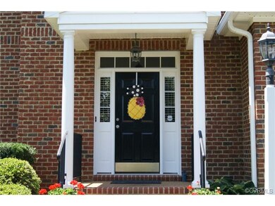Front porch with brick stairs & columns