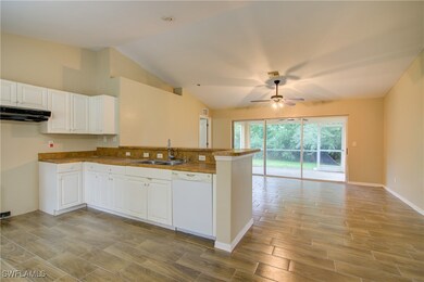 Kitchen featuring white dishwasher, a sink, a peni