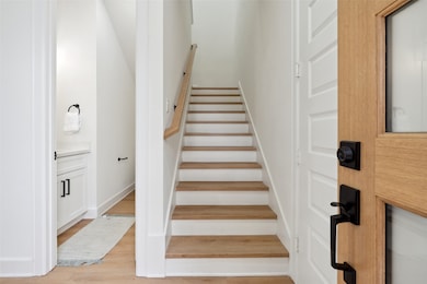 Step into elegance as you enter through the glass-paneled front door, where the foyer welcomes you with a sense of grace and sophistication. Illuminate your path with natural light streaming through, setting the tone for the exquisite living space that awaits beyond.